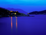 Fototapeta Na sufit - Moody landscape. Evening at the Mediterranean Sea with a view on the Dubrovnik lights, Lokrum island and distant mountains.