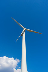 wind turbine against blue sky.