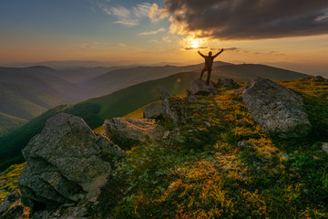 Mountain scenery in the Ukrainian Carpathians in the summer with a tourist in the background of the sunset