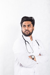 Canvas Print - Handsome young doctor in a white coat with a stethoscope. Health care concept.