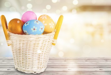 Poster - Easter basket filled with colorful eggs on a white background