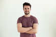 © nenetus - Handsome young man smiling and looking at camera over white background.