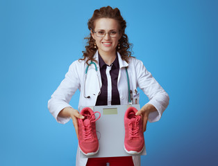 medical practitioner woman with weight scale and sneakers