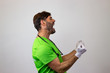 © Sergio Barceló - Portrait of male veterinary doctor in green uniform with brown hair screaming, facing forwards and looking at the side. Isolated on white background.