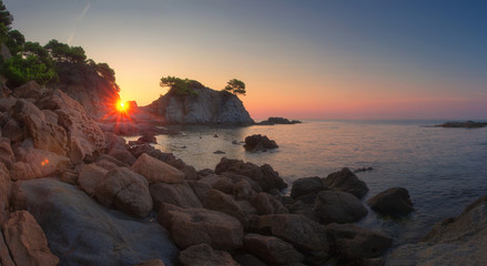 Fototapete - Landscape of beach at sunrise in Lloret de Mar, Spain coast. Costa Brava sea nature in morning sunshine