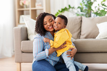 Childhood, Kids And People Concept - Happy African American Mother With Her Baby Son At Home