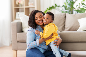 childhood, kids and people concept - happy african american mother with her baby son at home