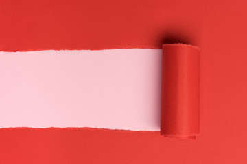 Wall Mural - Red torned paper over pink background