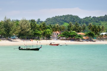 Tropical turquoise sea bay, paradise sandy beach, palm trees, tourist resorts, Haad Kwang Pao Beach in Khanom district of Nakhon Si Thammarat province of Thailand.