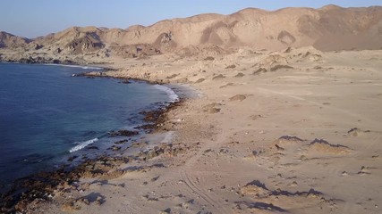 Wall Mural - las tortolas beach aerial footage at atacama desert the sunset ray lights illuminate this amazing an