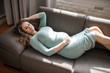 © Anna Vovk - Beautiful pregnant woman sits and touches belly with hands, pregnancy concept