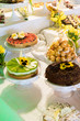 Gustownie nakryte i udekorowane stoły ciastami i ciasteczkami z okazji uroczystości rodzinnych lub spotkań okolicznościowych
