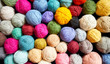 Colorful background made of many wool yarn balls.