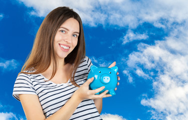 Canvas Print - Young woman with a piggy bank