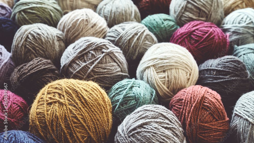 Vintage toned picture of wool yarn balls, shallow depth of field. - obrazy, fototapety, plakaty 
