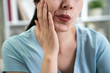 © PR Image Factory - unrecognized asian woman feeling tooth pain hands touching face cheek unhealthy problem at home. female suffering from strong teeth pain toothache. Dental health and care medical lifestyle concept