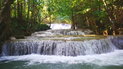 Wall Mural - Waterfall flow standing with forest enviroment low angle view in thailand called Huay or Huai mae khamin in Kanchanaburi Provience, Thailand., Tilt down.