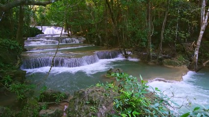 Wall Mural - Waterfall flow standing with forest enviroment high angle view in thailand called Huay or Huai mae khamin in Kanchanaburi Provience, Thailand., Zoom out.
