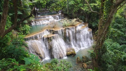 Wall Mural - Waterfall flow standing with forest enviroment from high angle view in thailand, called Huay orHuai mae khamin in Kanchanaburi Provience, Zoom in.