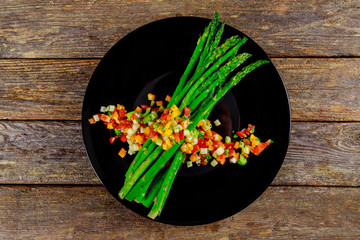 Wall Mural - Baked asparagus garnished with tomatoes with herbs.