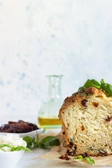 Savoury loaf cake with dried tomatoes, mozzarella and basil. Selective focus.