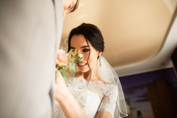 Traditionally, the bride in the house touches a small bouquet for the groom. Groom bouquet next to the hand on suit