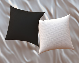 Two blank black and white soft square cotton pillows on gray satin bedsheet, messy bed sheets,  mockup for your design, 3D render