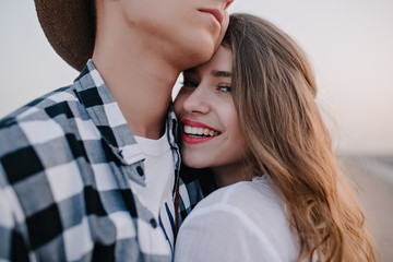close-up portrait of attractive smiling young woman in white shirt gladly posing with her stylish bo