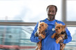 © JPC-PROD - Male veterinarian with stethoscope around neck, holding two dogs Yorkshire Terrier,in his arms.