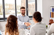 © Syda Productions - new job, hiring and employment concept - team of recruiters having interview with male employee and shaking hands at office