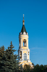 Wall Mural - Beautiful orthodox belfry behind the trees