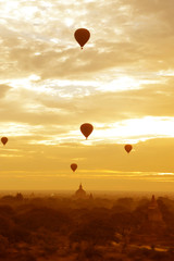 Sunset in buddhist temple,stupa,in the historical park of Bagan,Myanmar with air balloon in the sky