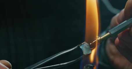 Wall Mural - Slow motion macro of experienced goldsmith working on high quality aquamarine stones selected for making precious jewels in workshop. Shot in 8K. Concept of jewelry, luxury, goldsmith, diamonds