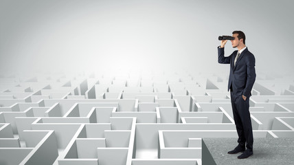 Wall Mural - businessman standing on maze and looking forward to the future concept