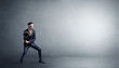 © ra2 studio - Small karate man fighting in an empty grey copy space