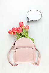 Wall Mural - Girl pink lether back pack with red tulips and speech bubble light box.