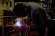 © Таиса Полиэктова - Welder in workshop with sparks