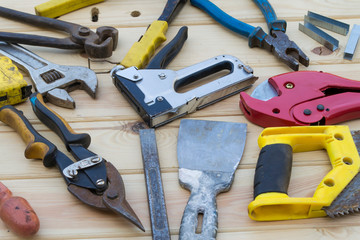 Various construction tools on a wooden table.