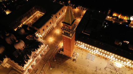 Wall Mural - Aerial drone night shot of iconic illuminated Saint Mark's square or Piazza San Marco featuring Doge's Palace, Basilica and Campanile, Venice, Italy