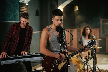 Wall Mural - Music band having rehearsal in a studio