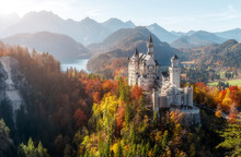 Summer Germany. Morning In The Bavarian Mountains. Castle Neuschwanstein In The Light Of The Rising Sun. Awesome Alpine Highlands In Sunny Day.  Popular Photography Locations. Beautiful Of The World
