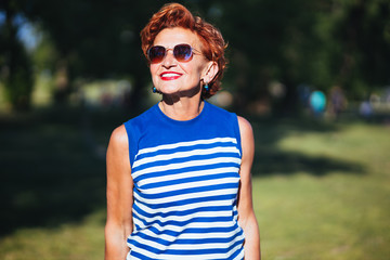 Wall Mural - Portrait of a mature woman walking in the park