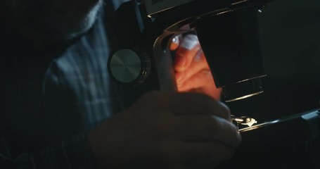 Wall Mural - Slow motion close up of experienced goldsmith controlling a quality of diamond stone, selected for making jewels in workshop. Shot in 8K. Concept of jewelry,luxury,goldsmith, diamonds, brilliance.