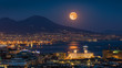 Full moon rises above Mount Vesuvius, Naples and Bay of Naples, Italy