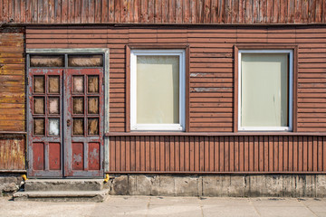 Walls and windows.The facade of the wooden house, door and windows