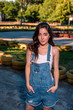 © Yura - Beautiful young woman in denim overalls on the go-kart track