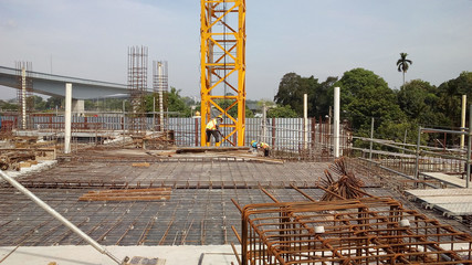 Wall Mural - Floor slab and beam reinforcement bar under fabrication at the construction site by workers. It is tied it together using tiny wires. 