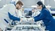 © Gorodenkoff - Shot of an Electronics Factory Workers Assembling Circuit Boards by Hand While it Stands on the Assembly Line. High Tech Factory Facility.