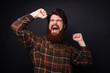 © Vulp - Excited bearded guy celebrating with risd hands and closed eyes, over dark wall background