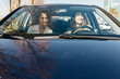 © Westend61 - Two women driving in a car through the city
